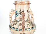 a vase that is sitting on a white surface