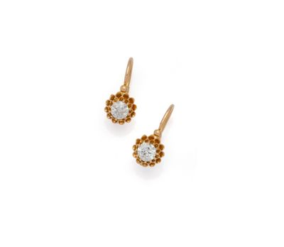 a pair of gold earrings with diamonds on a white background