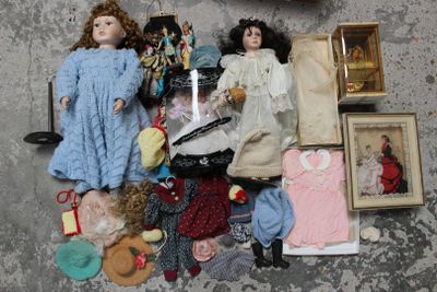 a lot of dolls that are sitting on the floor