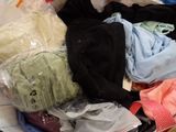 a pile of clothes that is sitting on the floor