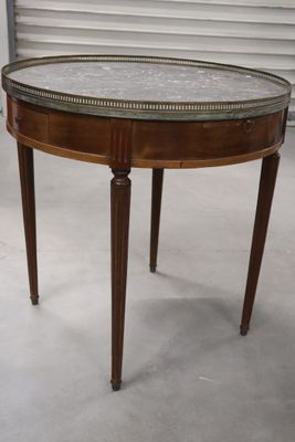 a small table with a glass top on a white floor