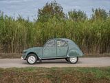 a green car that is driving down the road