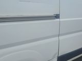 a white van that is parked on the side of the road