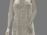 a mannequin dressed in a white dress on display