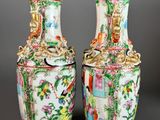 pair of chinese vases decorated with birds and flowers on a grey background