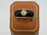 a close up of a ring on top of a brown leather box