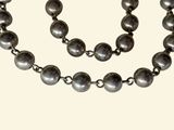 necklace and bracelet with silver beads on a white background