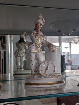 a glass shelf with a statue of a woman on it