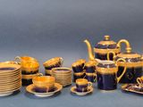 an image of a blue and gold tea set with cups and saucers