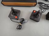 a video game controller and two controllers on a table