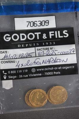 two gold coins in a plastic bag on a table