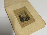 an old book with a picture on it on a table