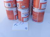 four cans of orange paint sitting on top of a white table