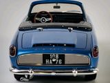 a blue car that is sitting on a white surface