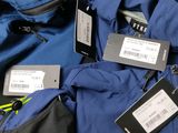 a pile of luggage that has tags on it