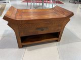a wooden table with a drawer on top of it