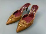 a close up of a pair of brown shoes on a table
