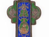 an ornate cross with a blue and green background and a picture of a woman on the cross