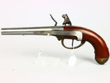 an old gun with a wooden handle on a white surface