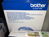 a brother printer sitting on a table next to a box