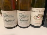 several bottles of wine are lined up on a table