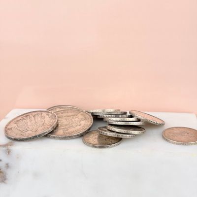 a pile of coins sitting on top of a marble counter top