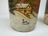 two cups with a picture of a house on them
