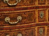 a wooden chest of drawers with many drawers on top of it