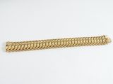 a gold bracelet on a white background