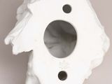 a white bird shaped vase with a hole in the middle