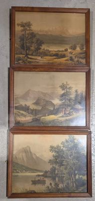 three framed paintings of a mountain scene hanging on a wall