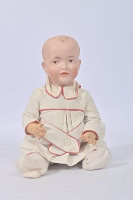a baby doll sitting on the ground with a white background