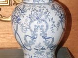 a blue and white vase sitting on top of a table