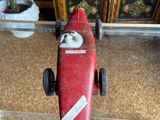 a small red toy car on a clear table