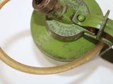 a green gas can with a hose attached to it