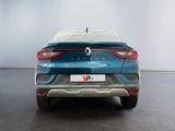 the rear end of a blue car in a white room