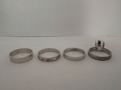 four rings sitting on a table with a flag on top of them