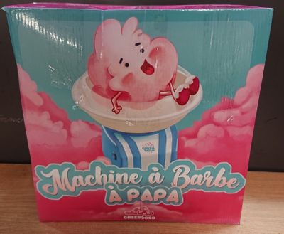 une boîte de bonbons contenant un cochon, posée sur une table