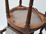 a wooden chair with a cushion on top of it