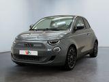 the grey car is parked in a large room with a black floor