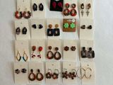 many pairs of earrings displayed on the wall