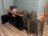 several chairs are lined up in a room with a brick wall