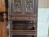 a wooden cabinet with carvings on it in a room