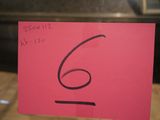 a note with the number six on it in front of a window