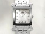 a close up of a watch on a white surface