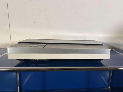 a television sitting on top of a metal shelf