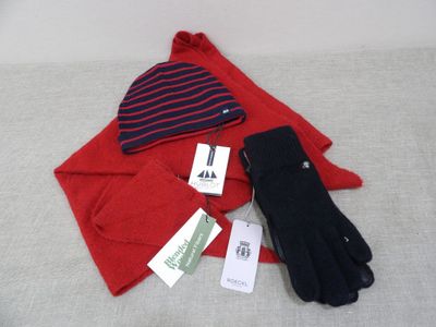 a pair of gloves, a hat, and a pair of gloves on a bed