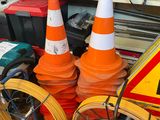 many orange and white cones sitting on the ground