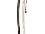 a close up of a sword on a white surface