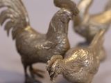 three metal birds that are standing next to each other